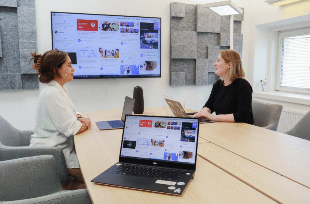 2 Women Sitting in a High-Tech Conference Room